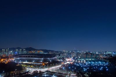 Aerial view of illuminated cityscape against sky at night