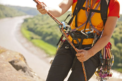 Close up of woman rappelling of cliff in south wales