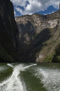 Scenic view of waterfall against mountains