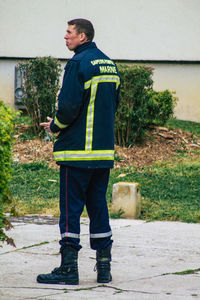 Full length of man standing against wall