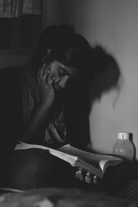 Woman sitting on table at home