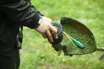 Midsection of man holding plant