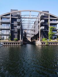 Bridge over river against buildings in city