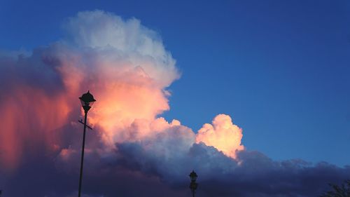 Low angle view of street light against cloudy sky during sunset