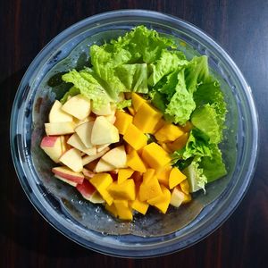 High angle view of chopped fruits in bowl on table