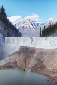 Blurred motion of waterfall against mountains