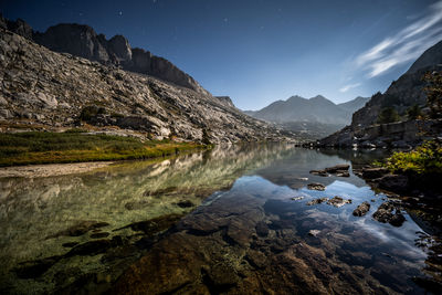 Scenic view of lake against sky at night