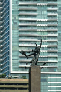 Low angle view of statue against building