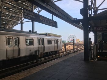 Train at railroad station platform against sky