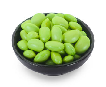 Close-up of green beans in bowl against white background