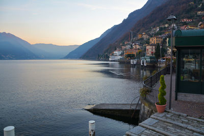 Town by sea and mountains against sky