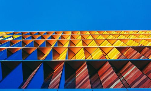 Multi colored building against blue sky