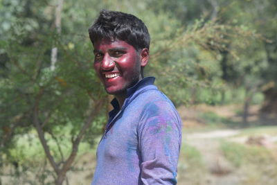 Man covered in powder paint standing outdoors