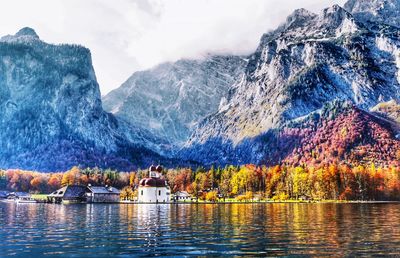 Scenic view of lake with snowcapped mountain in background