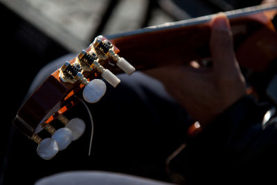 Close-up of guitar in persons hand