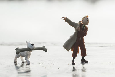 Full length of men with toy on beach