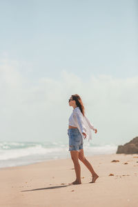 Young woman standing at beach