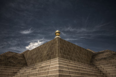 Low angle view of built structure against cloudy sky