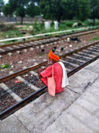 High angle view of red flower on railroad track