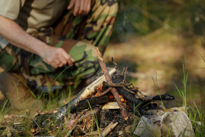 Midsection of man working on barbecue grill