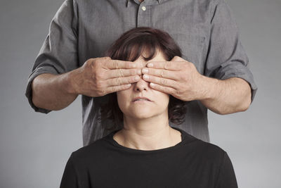 Close-up of hands against white background