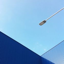 Low angle view of street light against clear blue sky