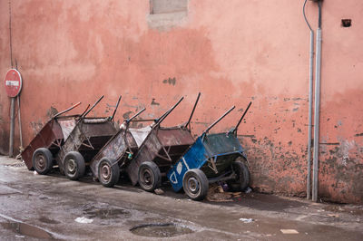 Motorcycle on street against wall