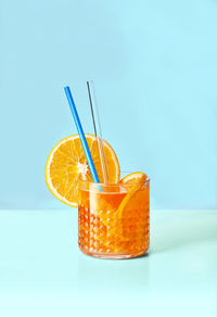 Close-up of drink in glass against blue background