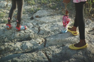 Low section of girls standing on rock