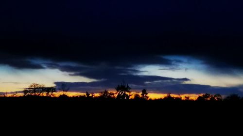 Scenic view of silhouette landscape against dramatic sky