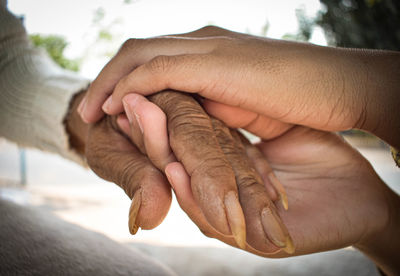 Close-up of couple holding hands