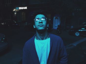 Portrait of young man standing in car