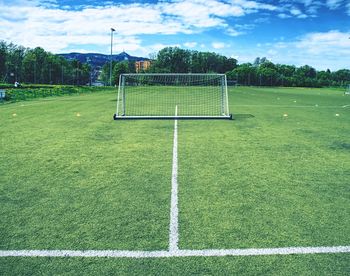 View of soccer field against cloudy sky