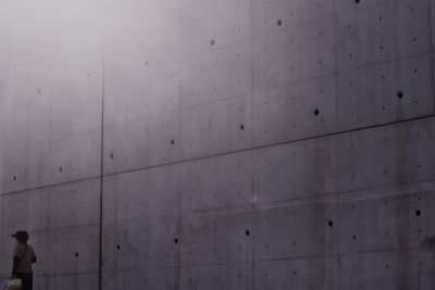 Low angle view of people walking on wall