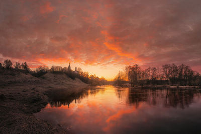 Scenic view of lake against orange sky