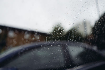 Close-up of wet car window during rainy season