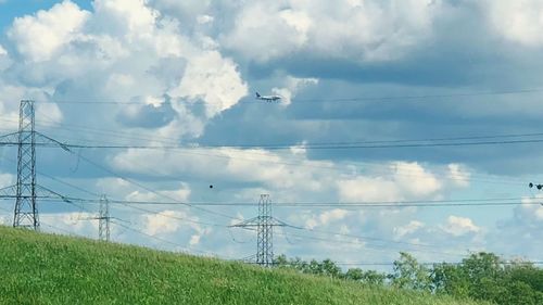 Low angle view of electricity pylon against sky