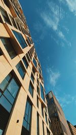 Low angle view of modern building against blue sky