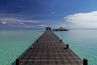 Pier over sea against sky
