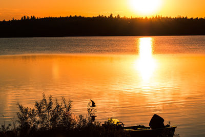 Scenic view of lake against orange sky