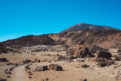 Scenic view of rocky mountains against clear blue sky