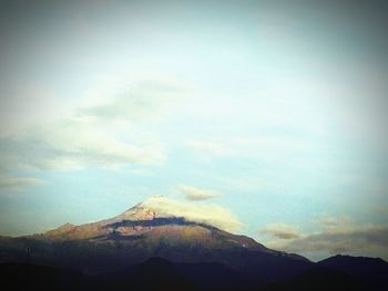 Scenic view of mountains against cloudy sky