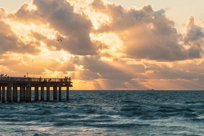 Scenic view of sea and pier against sky during suntuario