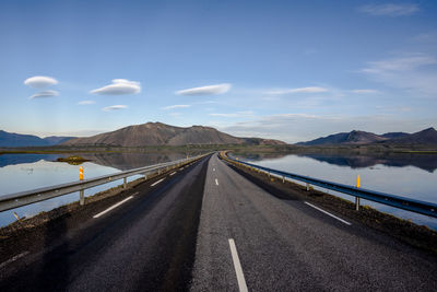 Road by mountain against sky