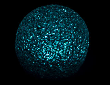 Close-up of crystal ball against black background