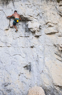 Man climbing rock face in yangshuo