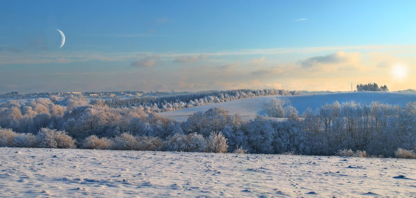 Scenic view of snow covered landscape against sky