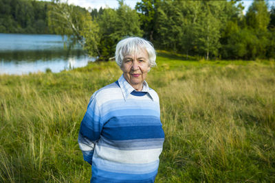 Portrait of senior woman standing at park