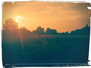 Scenic view of landscape against sky at sunset