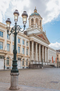 Facade of historical building against cloudy sky